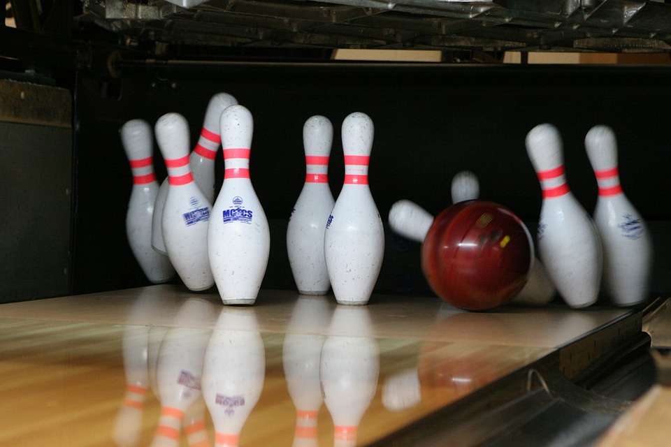 Bowling ball striking bowling pins